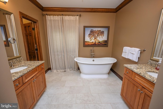 bathroom with a soaking tub, crown molding, two vanities, and a sink