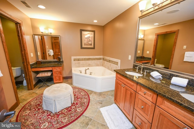 bathroom with toilet, double vanity, visible vents, and a sink