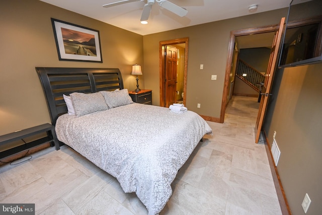 tiled bedroom featuring ceiling fan