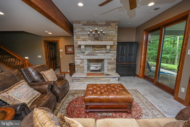 living area featuring recessed lighting, stairs, baseboards, and a stone fireplace