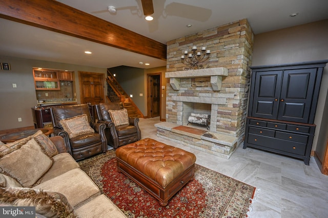 living room featuring ceiling fan, light tile patterned flooring, a stone fireplace, and beamed ceiling