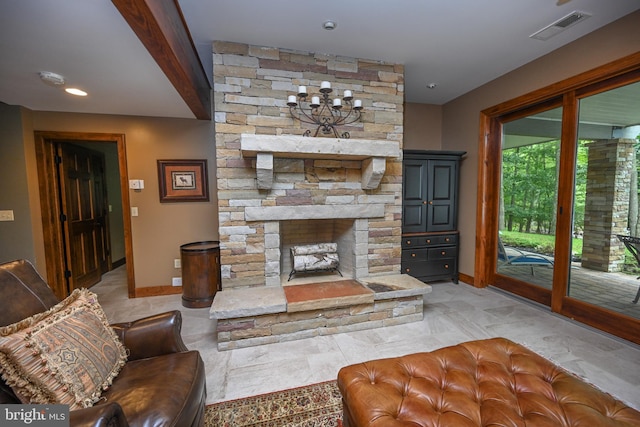 living area with baseboards, visible vents, and a stone fireplace