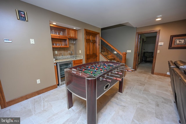 game room with light tile patterned floors, wine cooler, and bar