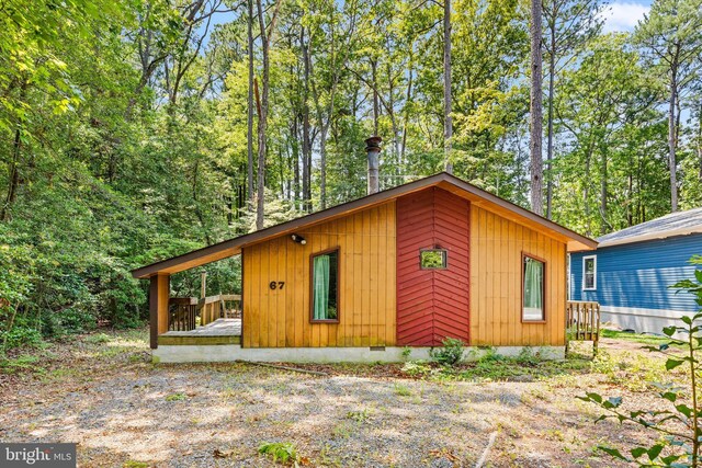 view of side of property featuring a wooden deck