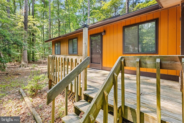 view of exterior entry featuring a wooden deck