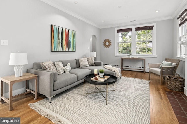 living room featuring wood-type flooring, ornamental molding, and a baseboard radiator