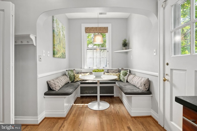 sitting room with breakfast area, hardwood / wood-style flooring, and plenty of natural light