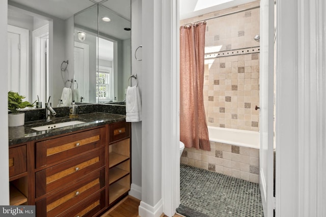 full bathroom featuring shower / tub combo with curtain, vanity, and toilet