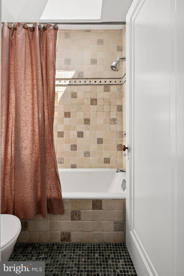 bathroom featuring shower / bath combo, tile patterned floors, and toilet