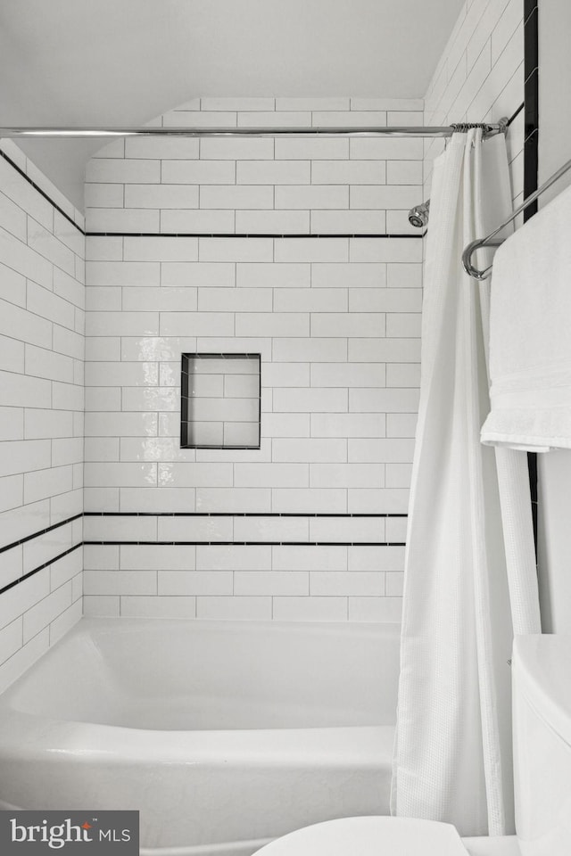 bathroom with shower / tub combo and toilet