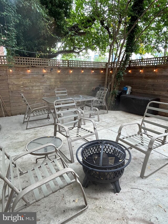 view of patio with a fire pit