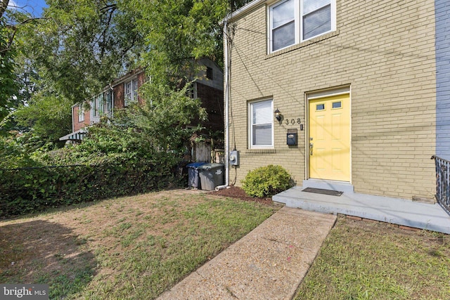 property entrance with a yard