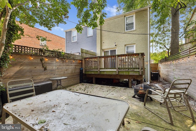 back of property featuring an outdoor fire pit, a patio area, and a deck