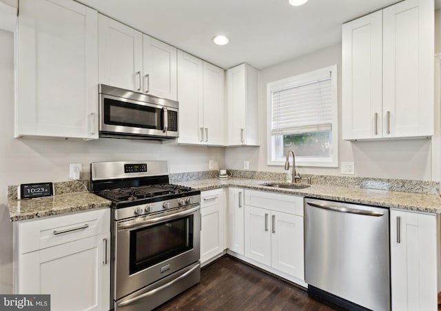 kitchen featuring stainless steel appliances, white cabinets, and sink