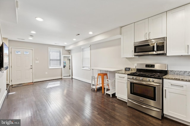 kitchen featuring light stone countertops, white cabinets, and appliances with stainless steel finishes