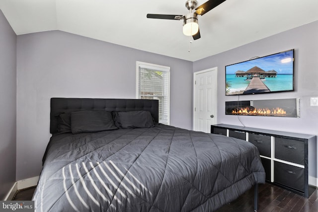 bedroom featuring dark wood-type flooring, ceiling fan, and lofted ceiling