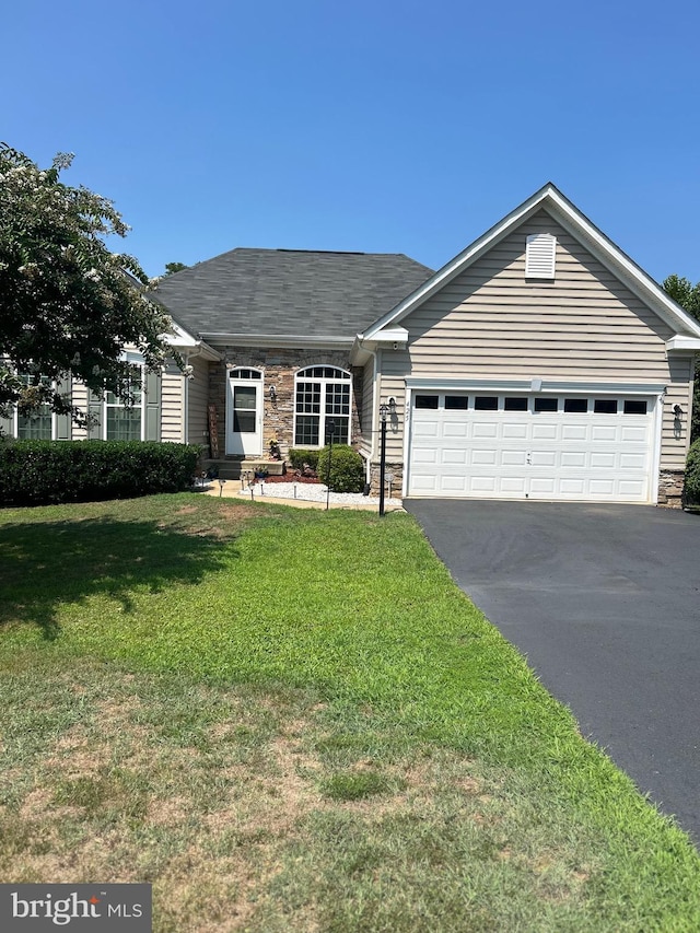 single story home with a garage and a front lawn