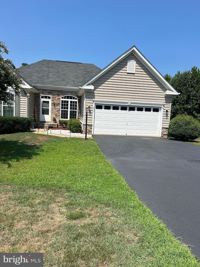 single story home featuring a garage and a front lawn