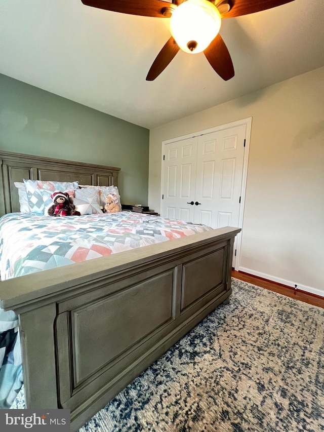 bedroom featuring ceiling fan and a closet