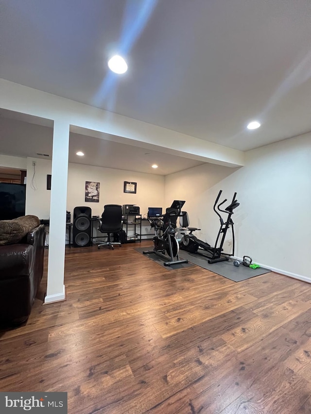 workout area with dark hardwood / wood-style floors