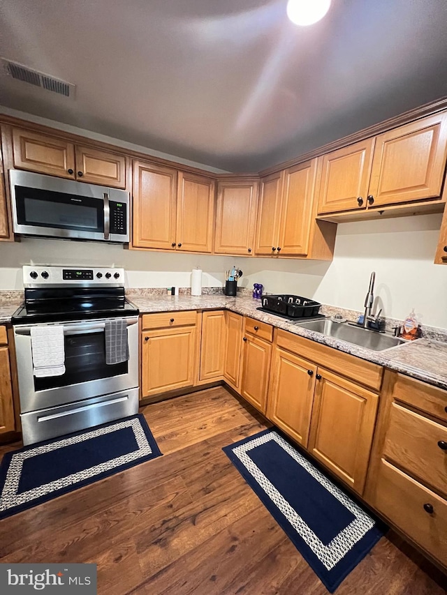 kitchen featuring sink, light wood-type flooring, and appliances with stainless steel finishes