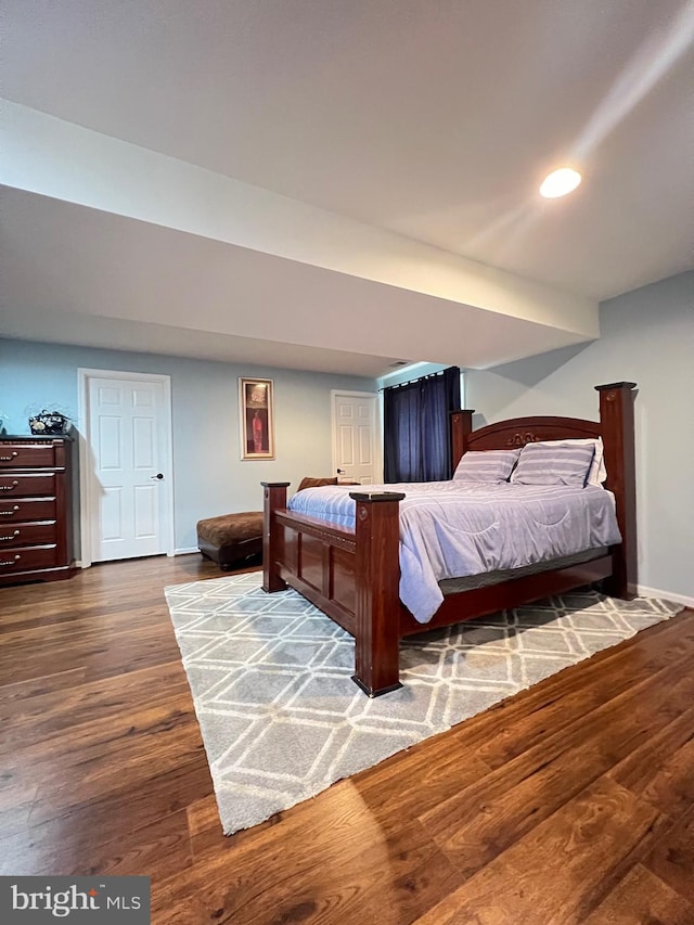 bedroom with dark wood-type flooring