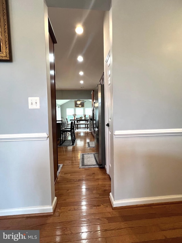 corridor with dark hardwood / wood-style flooring