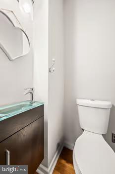 bathroom featuring hardwood / wood-style floors, vanity, and toilet