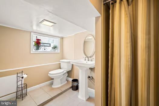 bathroom featuring tile patterned flooring and toilet