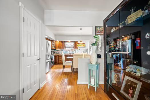 interior space featuring stainless steel refrigerator and light wood-type flooring