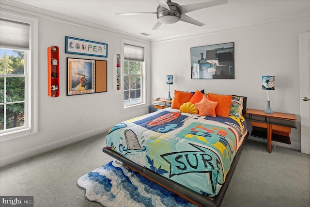 carpeted bedroom with ceiling fan, crown molding, and multiple windows