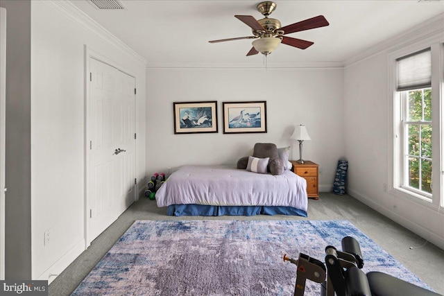 carpeted bedroom featuring ornamental molding and ceiling fan