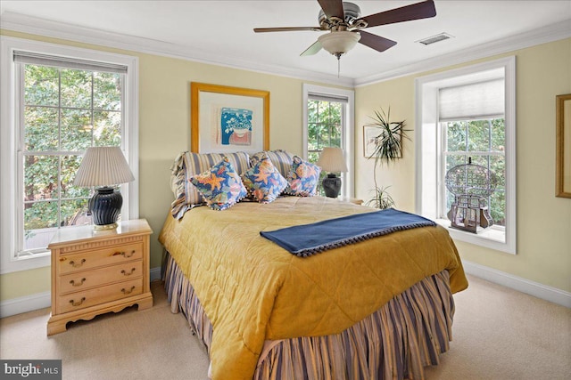 carpeted bedroom with crown molding and ceiling fan