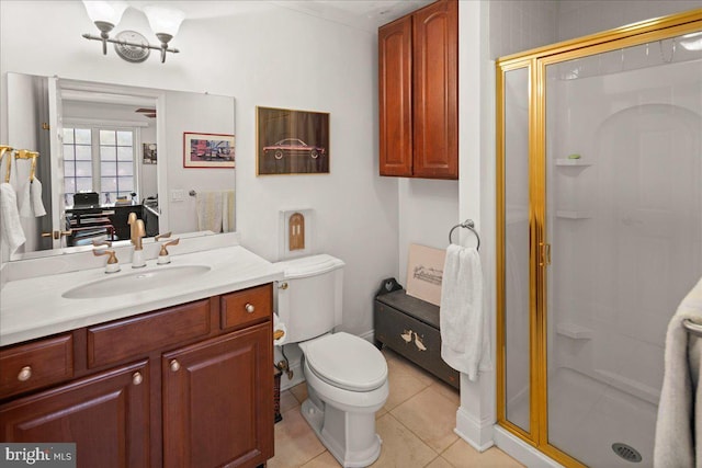 bathroom featuring vanity, a shower with shower door, toilet, and tile patterned flooring