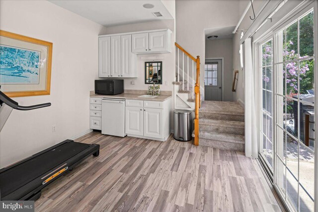 interior space featuring sink and light hardwood / wood-style flooring