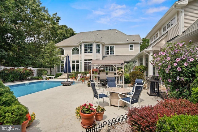 view of swimming pool featuring a pergola, a patio area, and a grill