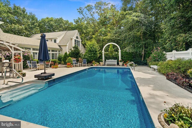 view of swimming pool featuring a patio area