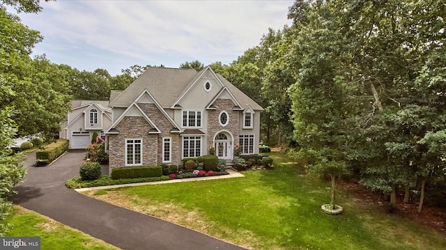 view of front of property featuring a front lawn and a garage