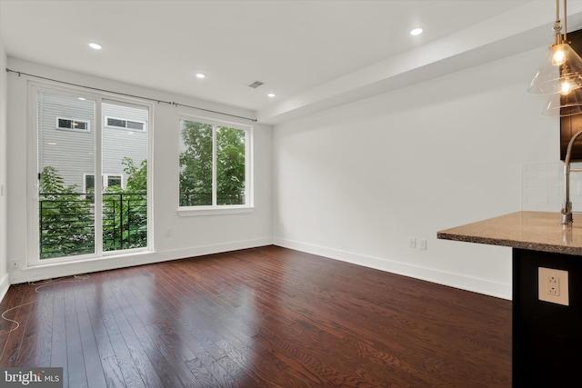 unfurnished living room with dark hardwood / wood-style floors