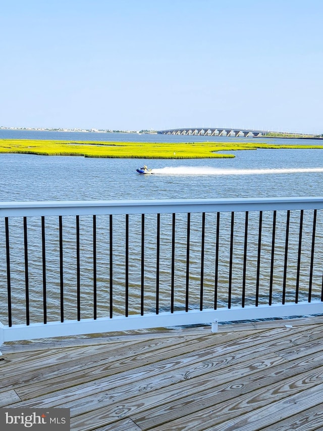 wooden deck featuring a water view