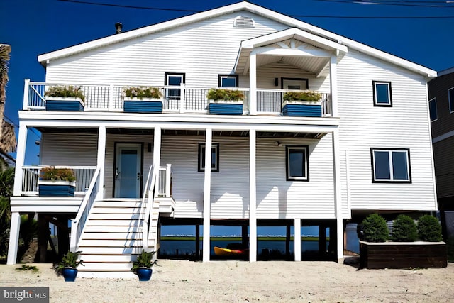 view of front facade featuring a balcony and covered porch