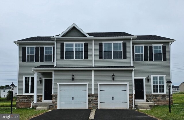 view of front of property featuring a garage and a front lawn