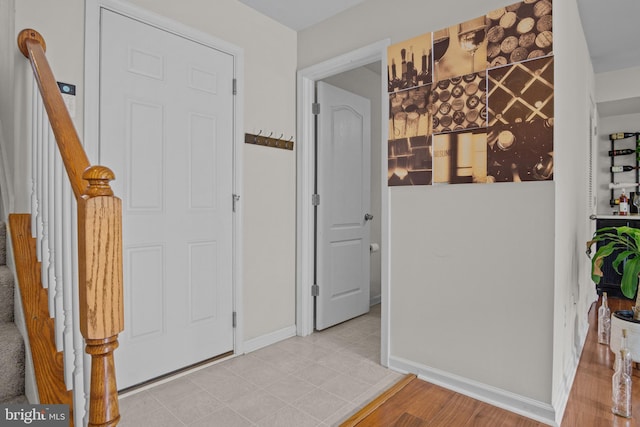 foyer entrance with light tile patterned floors