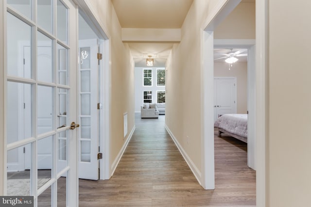 corridor with wood-type flooring