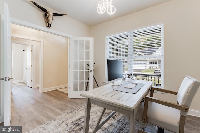 office area with light wood-type flooring and french doors