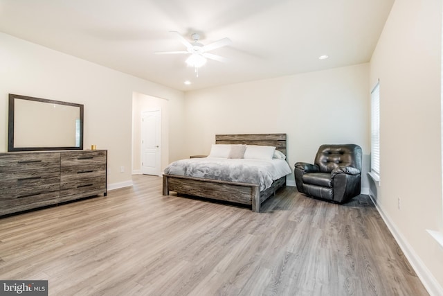 bedroom with light hardwood / wood-style flooring and ceiling fan