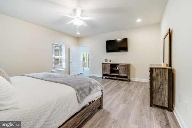 bedroom with light hardwood / wood-style flooring and ceiling fan