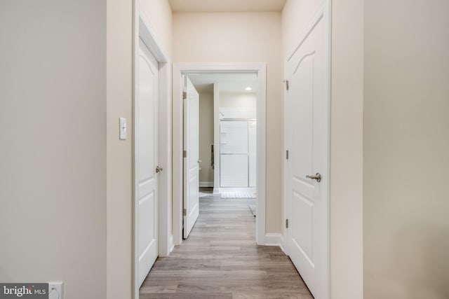 corridor with light wood-type flooring