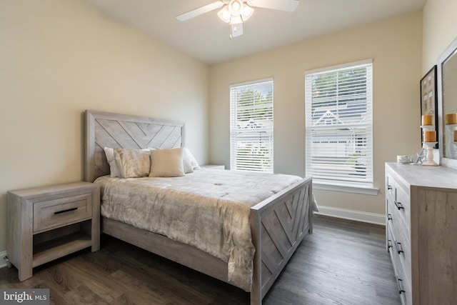 bedroom with dark hardwood / wood-style floors and ceiling fan