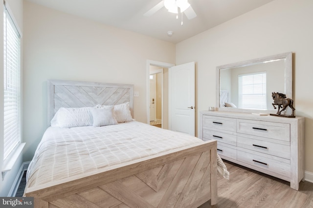 bedroom with ceiling fan and light hardwood / wood-style floors